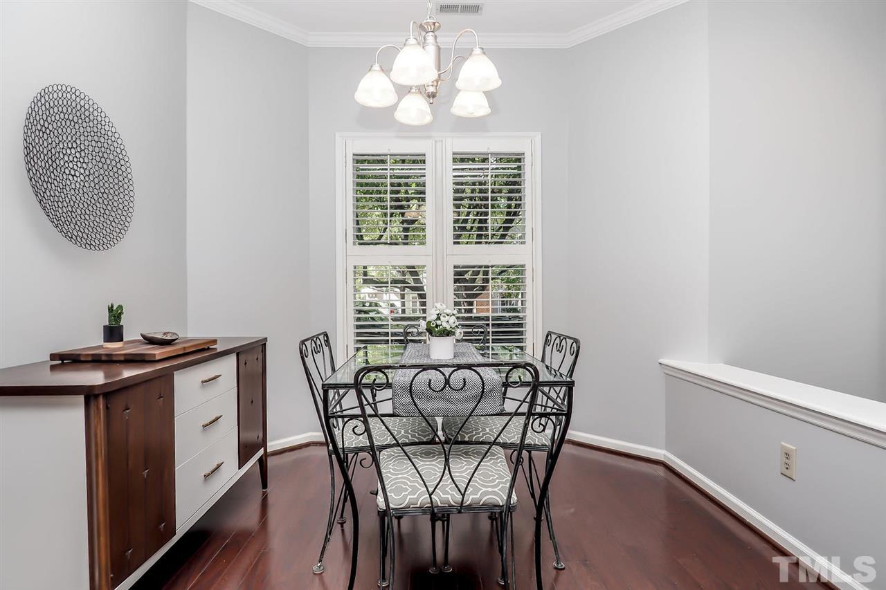 1001 Brighthurst Drive, Unit 103 Raleigh, NC 27605 - Photo 5 of 16 a view of a dining room with furniture window and wooden floor