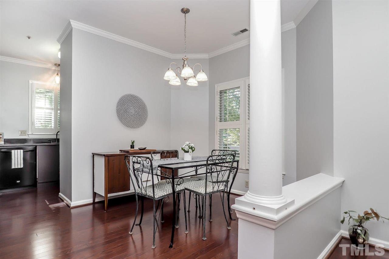 1001 Brighthurst Drive, Unit 103 Raleigh, NC 27605 - Photo 6 of 16 a view of a dining room with furniture and wooden floor