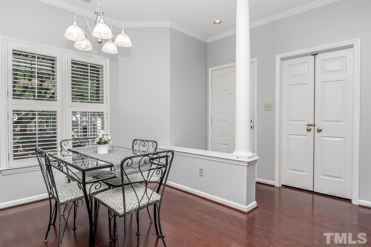 1001 Brighthurst Drive, Unit 103 Raleigh, NC 27605 - Photo 7 of 16 a view of a dining room with furniture and chandelier