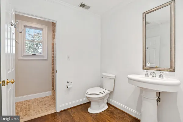 a bathroom with a sink toilet and a mirror