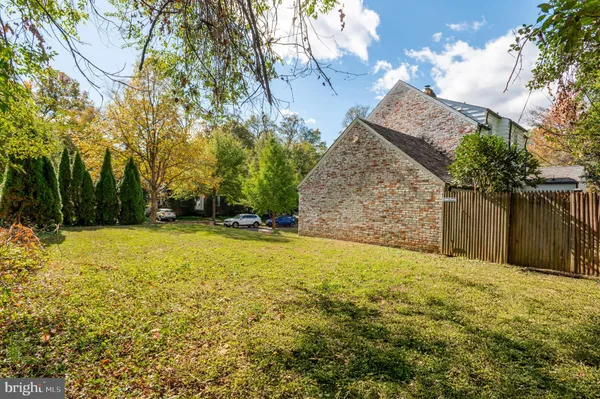 a view of backyard of house with green space