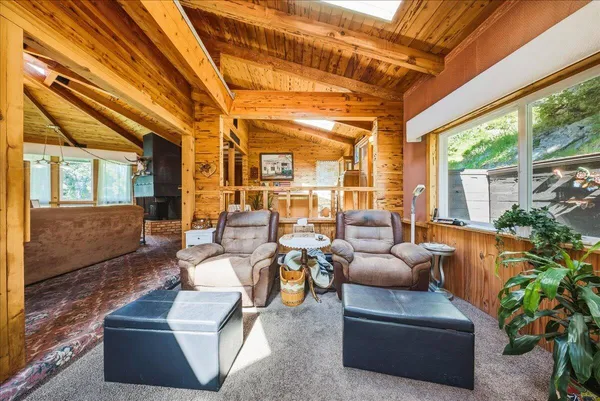 a living room with furniture and a floor to ceiling window