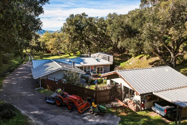 an aerial view of a house with a yard table and chairs