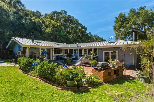a front view of house with yard outdoor seating and green space