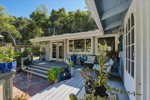 front view of a house with a chairs in a patio