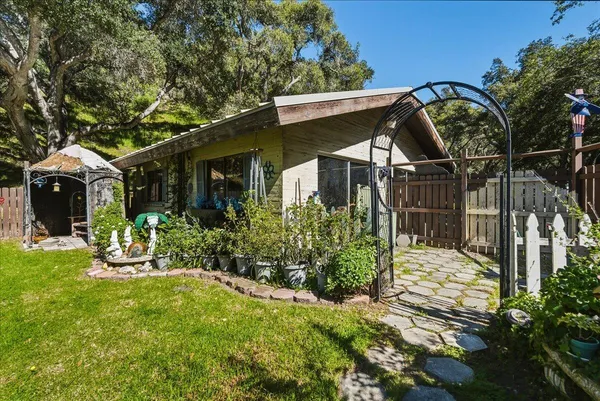 a front view of a house with garden