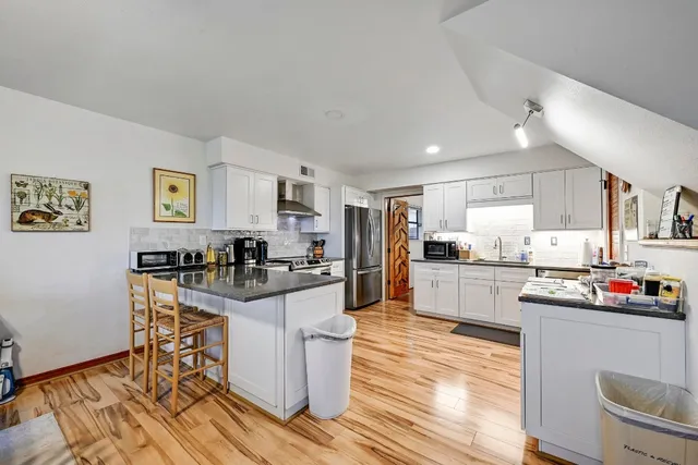 a kitchen with granite countertop stainless steel appliances and wooden cabinets