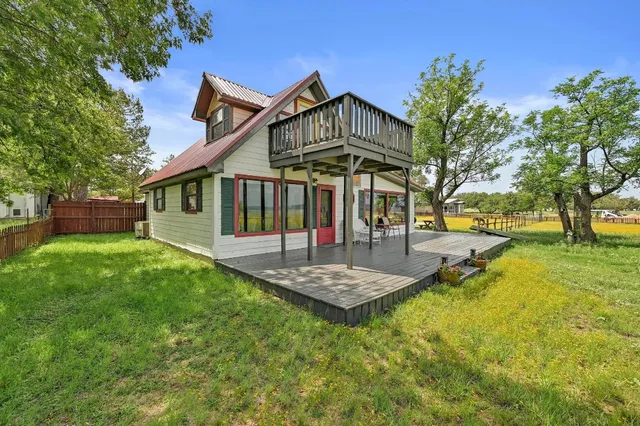 a view of a house with a yard patio and fire pit