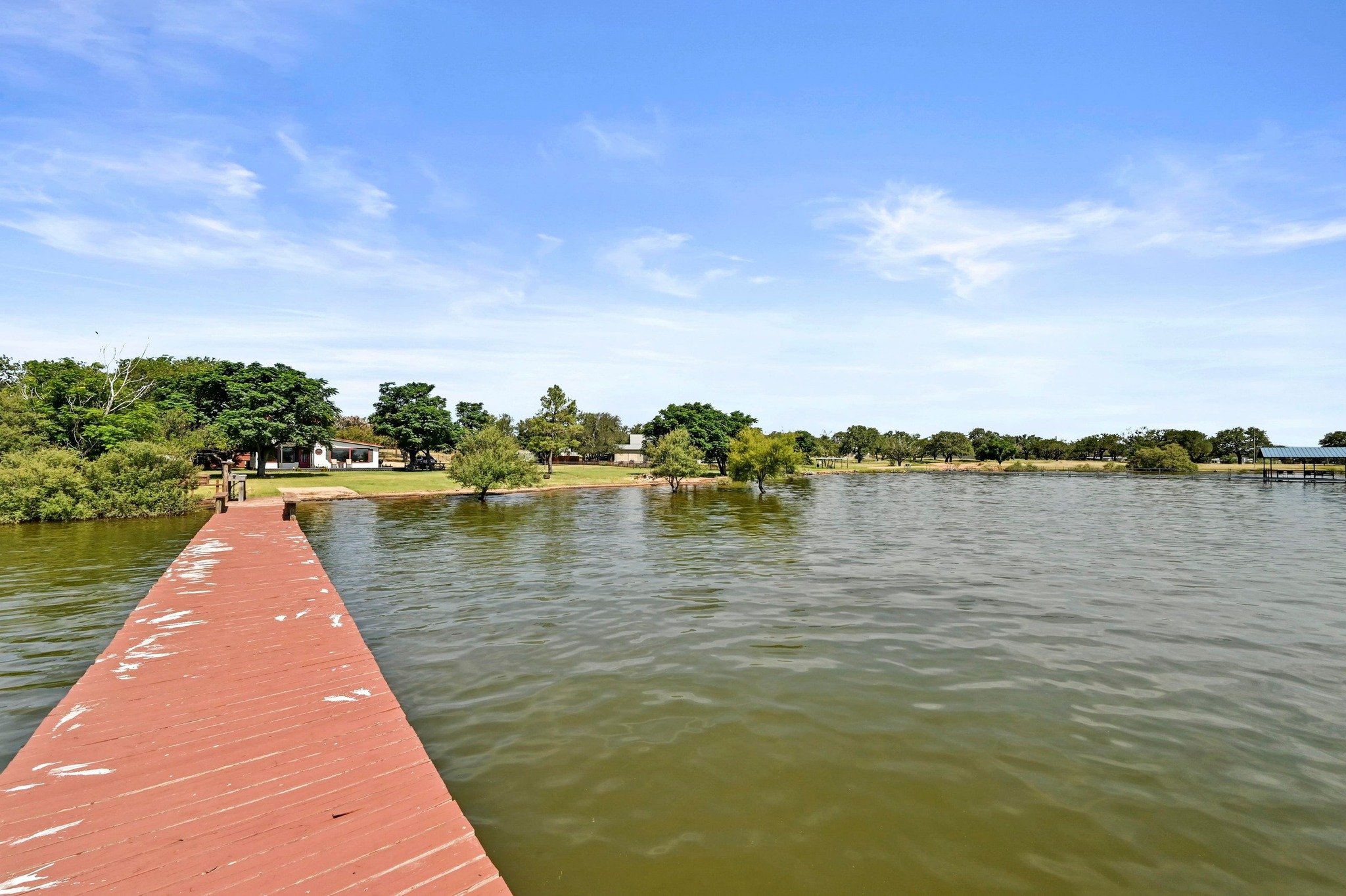 734 Island Drive Bluffton, TX 78607 - Photo 7 of 40 a wooden pier with boats in a lake