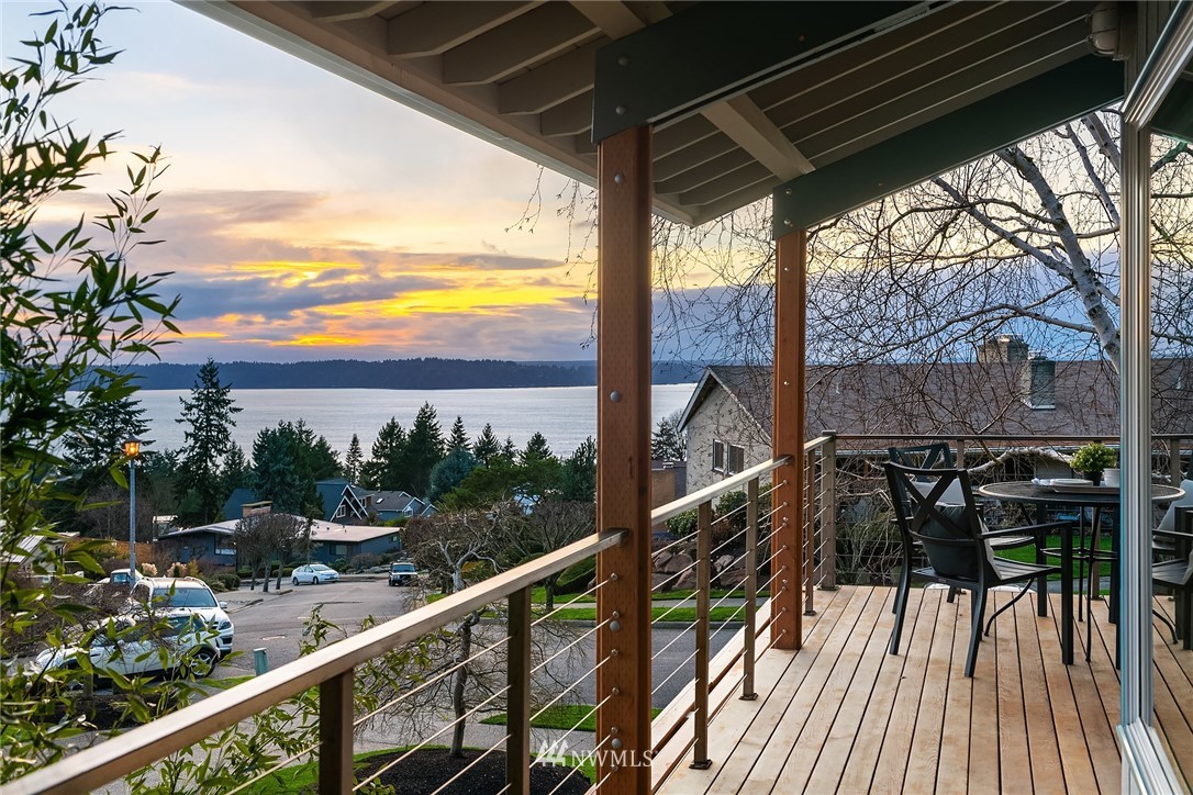 8560 Fauntlee Crest Southwest Seattle, WA 98136 - Photo 1 of 30 a view of balcony with chairs and wooden fence