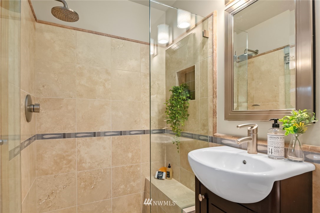 8560 Fauntlee Crest Southwest Seattle, WA 98136 - Photo 14 of 30 a bathroom with a sink mirror and a shower