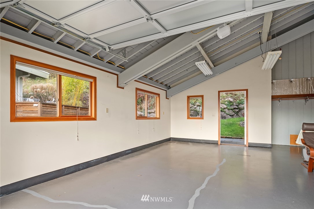 8560 Fauntlee Crest Southwest Seattle, WA 98136 - Photo 25 of 30 a view of an empty room with wooden floor and a window