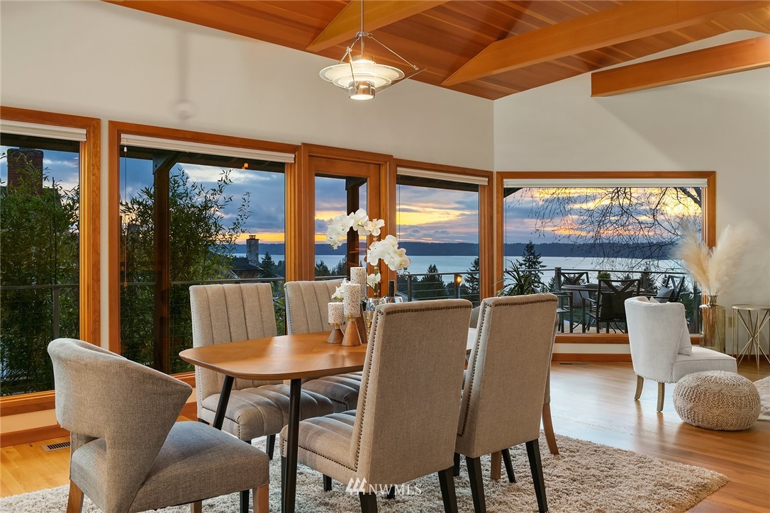 8560 Fauntlee Crest Southwest Seattle, WA 98136 - Photo 3 of 30 a dining room with furniture a chandelier and glass door
