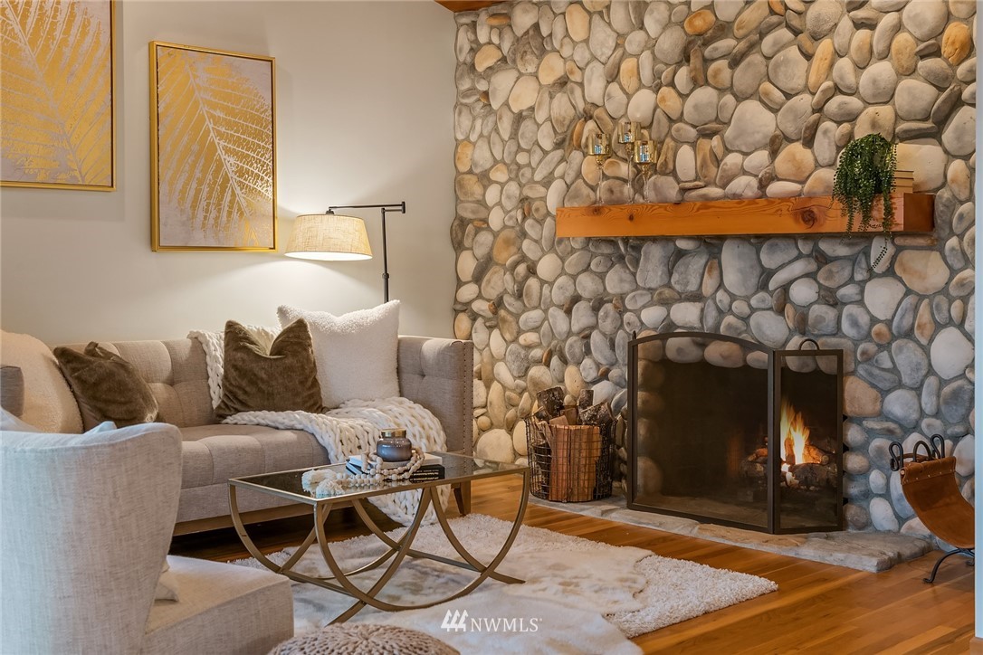 8560 Fauntlee Crest Southwest Seattle, WA 98136 - Photo 4 of 30 a living room with furniture and a fireplace