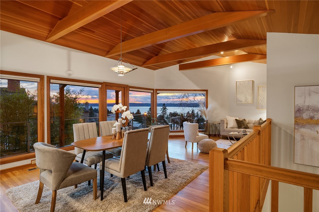 8560 Fauntlee Crest Southwest Seattle, WA 98136 - Photo 6 of 30 a view of a dining room with furniture wooden floor and a potted plant