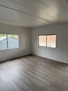 681 South Market Road Earlimart, CA 93219 - Photo 11 of 13 an empty room with wooden floor and windows
