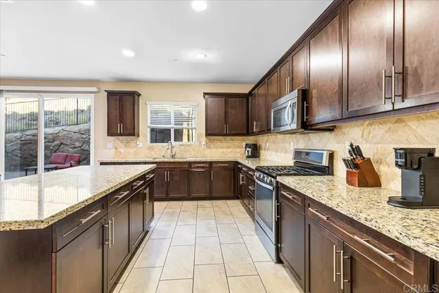 a large kitchen with granite countertop lots of counter top space
