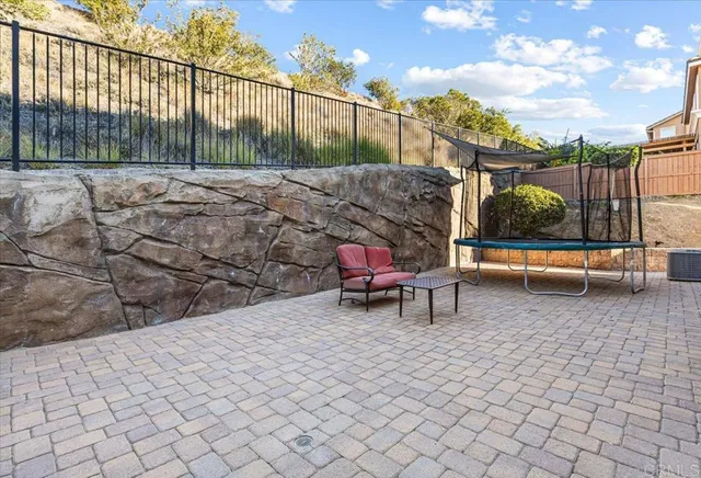 a view of a backyard with sitting area