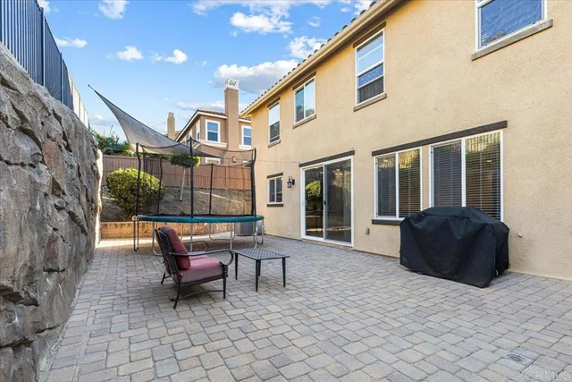 a building outdoor space with patio furniture and potted plants