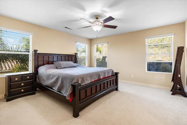 a bed sitting in a bedroom next to a window