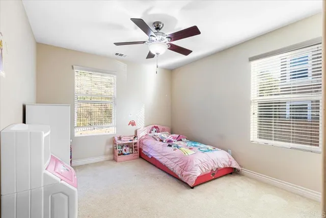 a bedroom with a bed and window