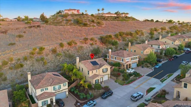 an aerial view of houses with a street