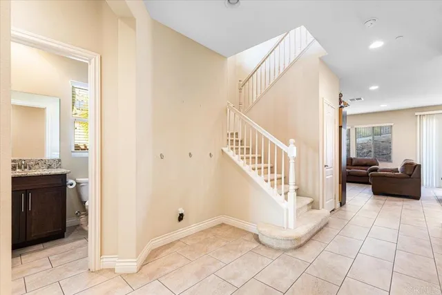 a view of a hallway view with staircase and living room