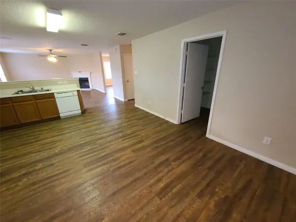 a view of a refrigerator in kitchen and a sink