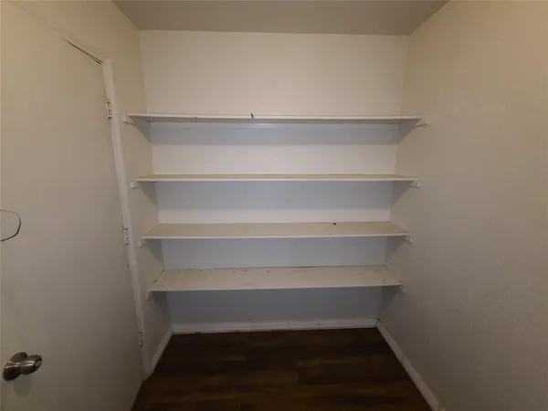 a view of walk in closet with empty racks