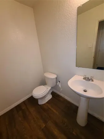 a white toilet sitting next to a white sink