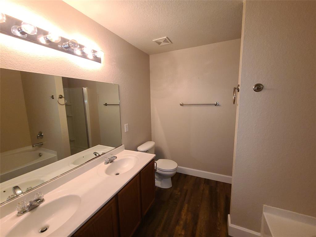 12141 Shine Avenue Rhome, TX 76078 - Photo 24 of 40 a bathroom with a sink a toilet and shower