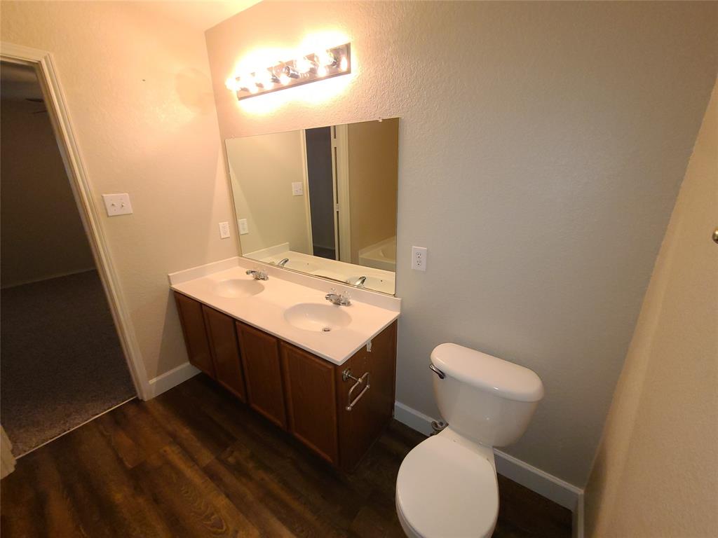 12141 Shine Avenue Rhome, TX 76078 - Photo 27 of 40 a bathroom with a sink toilet and mirror