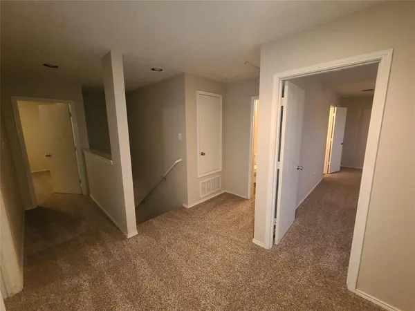 an empty room with a bathroom and a sink