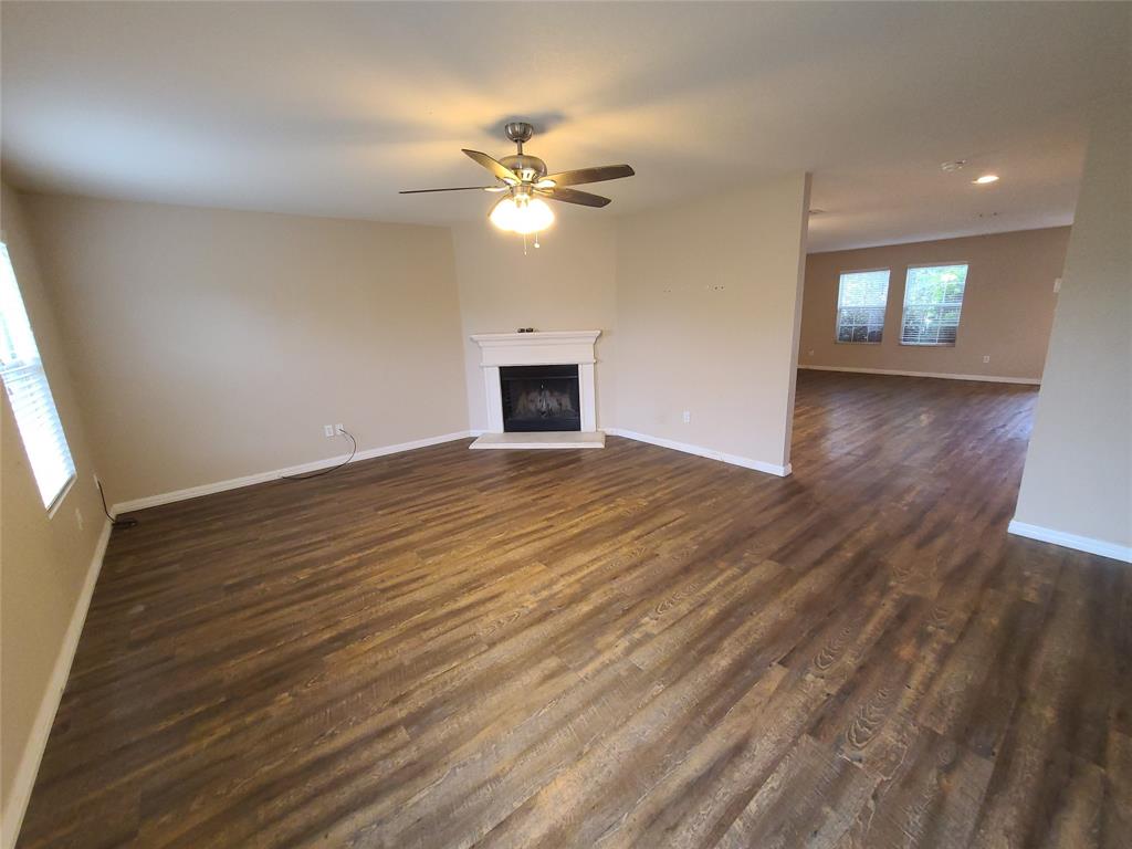 12141 Shine Avenue Rhome, TX 76078 - Photo 3 of 40 a view of empty room with wooden floor and fan