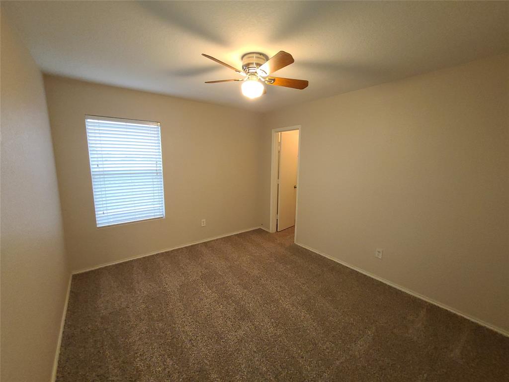 12141 Shine Avenue Rhome, TX 76078 - Photo 31 of 40 an empty room with windows and fan