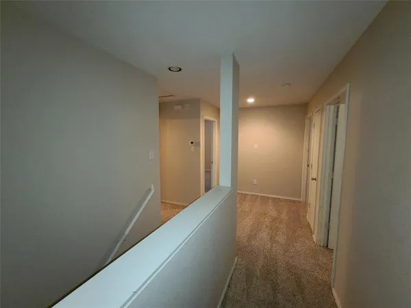 a view of hallway with wooden floor
