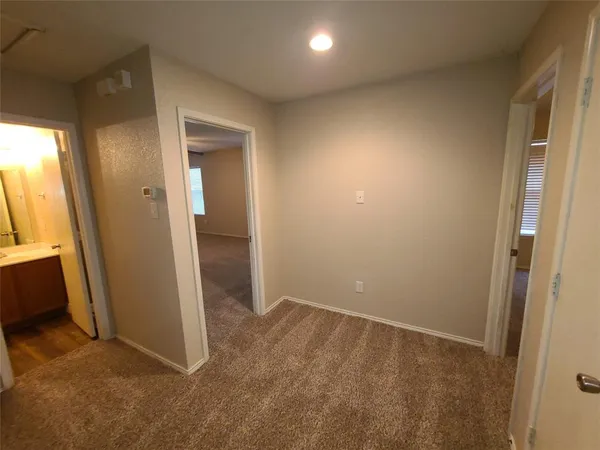 an empty room with closet and mirror