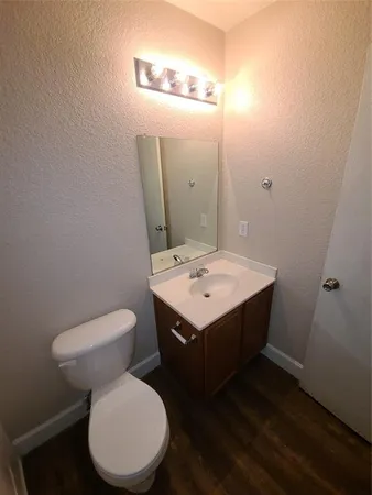a bathroom with a sink toilet and mirror