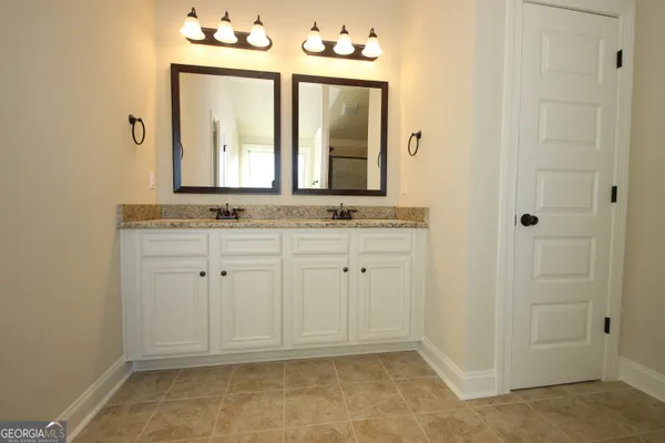 a bathroom with a sink vanity and mirror
