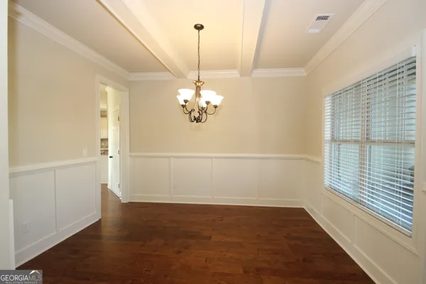 a view of a room with wooden floor and large window