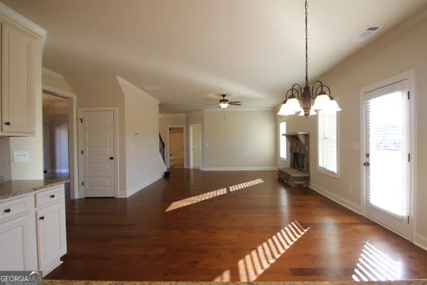 a view of a room with wooden floor and windows