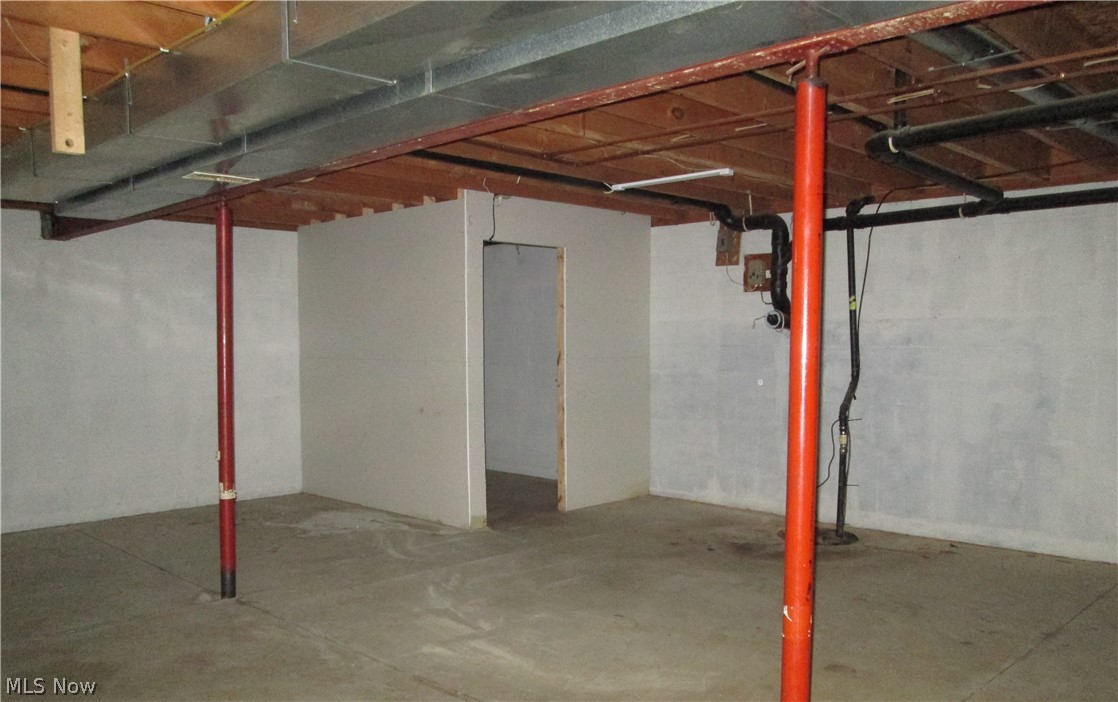 13096 Smith Road Wellington, OH 44090 - Photo 20 of 24 Unfinished basement space with concrete flooring, exposed ceiling joists, galvanized ductwork, and partial drywall framing
