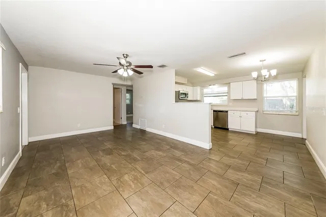 a view of a kitchen with a sink and a refrigerator