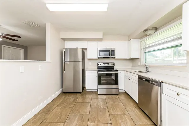 a kitchen with stainless steel appliances a refrigerator stove and microwave