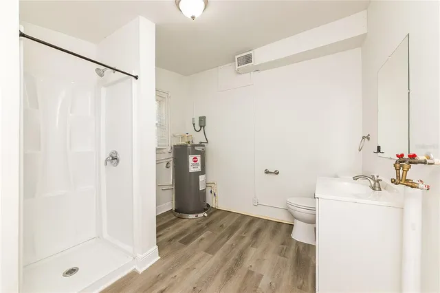 a bathroom with a sink toilet and shower