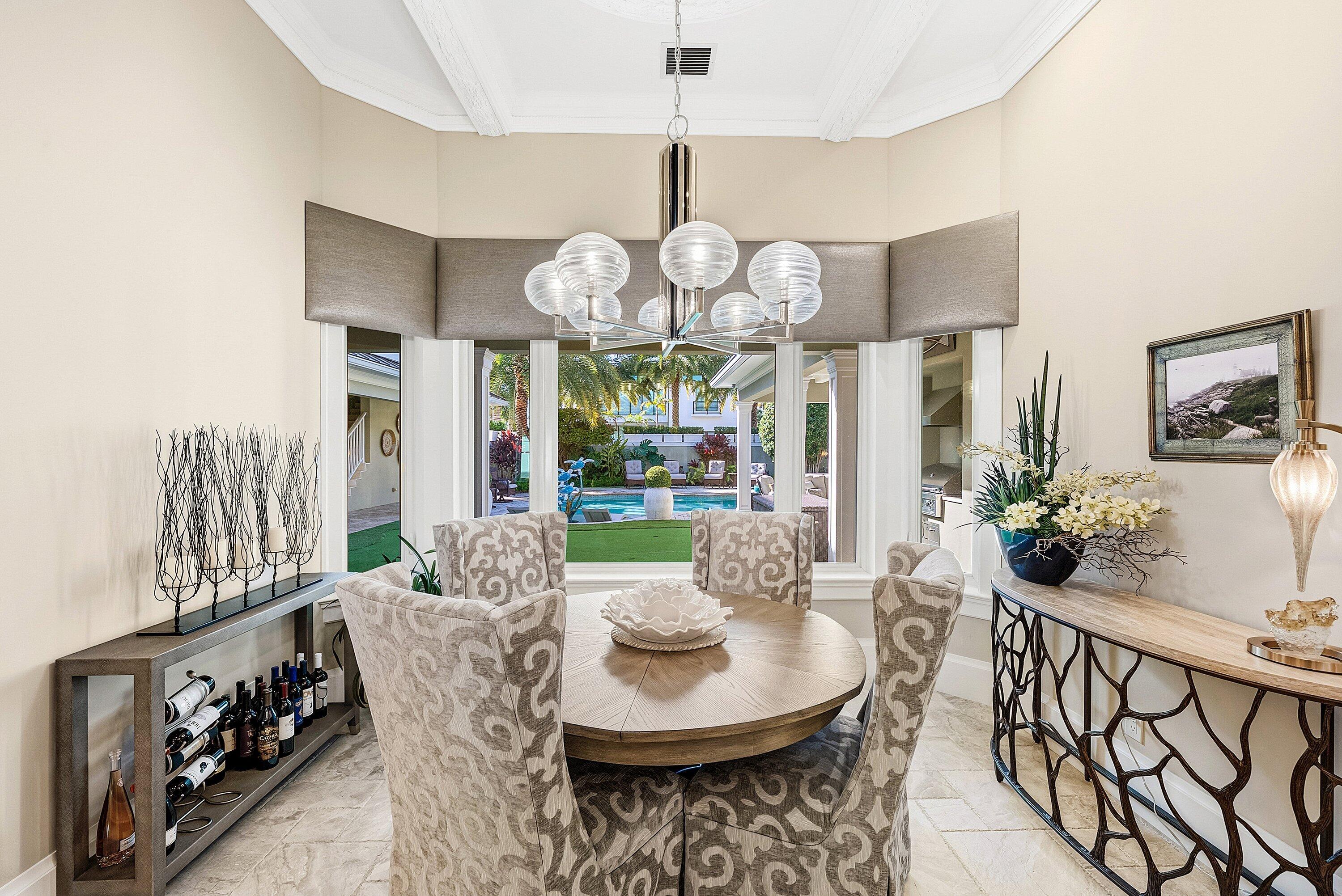 201 Northeast 3rd Court Boca Raton, FL 33432 - Photo 19 of 84 a view of a dining room with furniture a chandelier and wooden floor