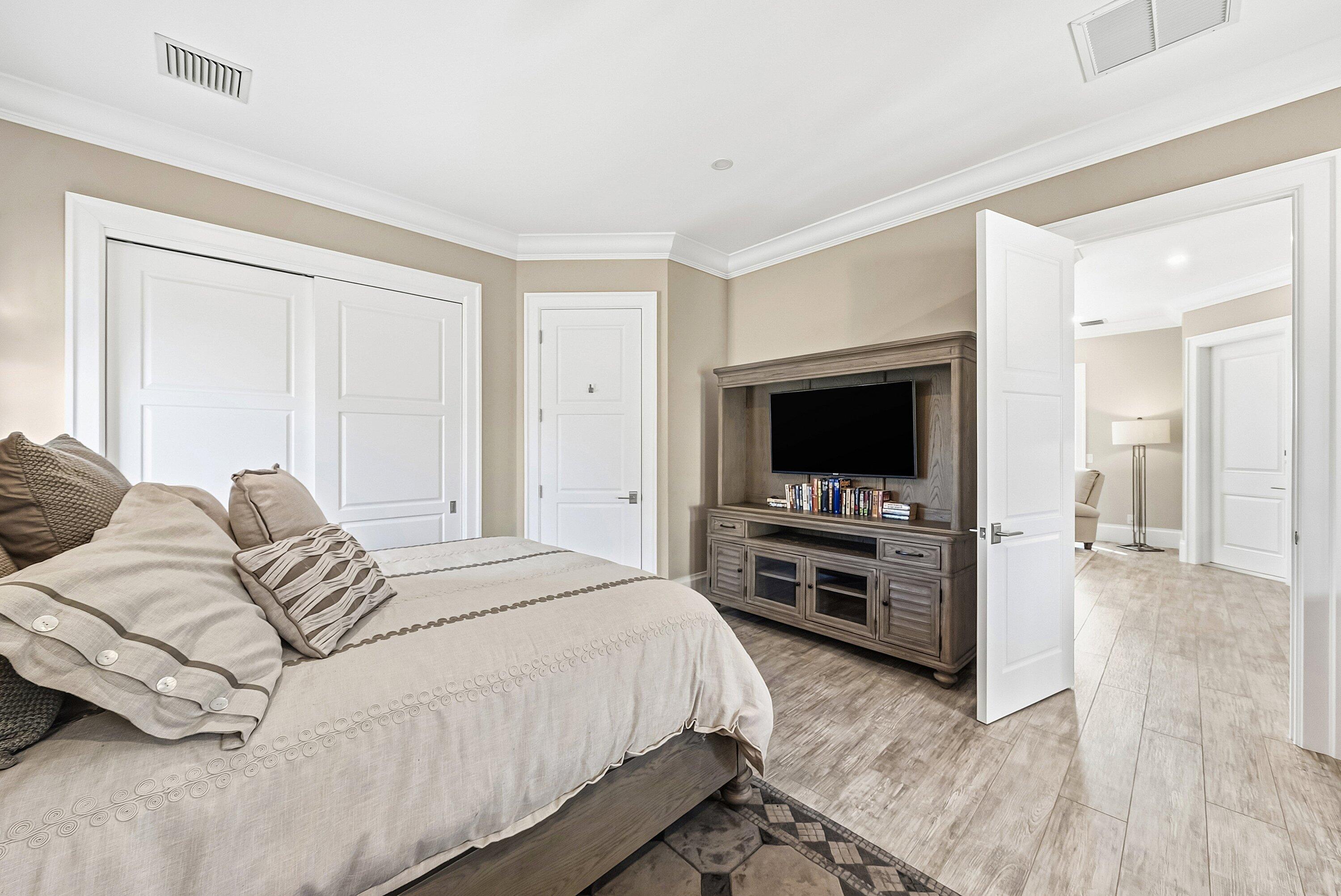 201 Northeast 3rd Court Boca Raton, FL 33432 - Photo 23 of 84 a bedroom with a bed and a flat screen tv