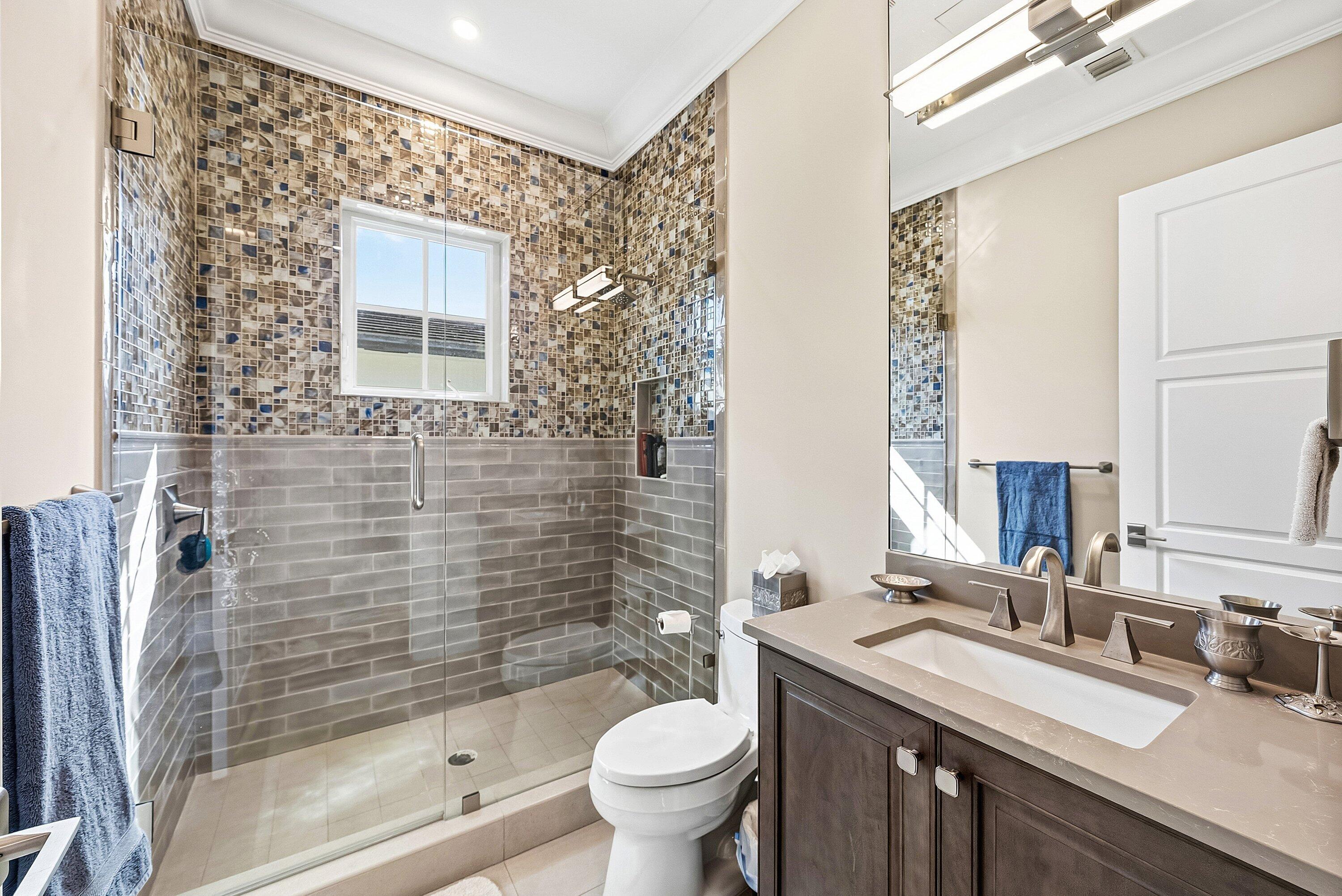 201 Northeast 3rd Court Boca Raton, FL 33432 - Photo 24 of 84 a bathroom with a granite countertop toilet a sink a mirror a shower and a bathtub