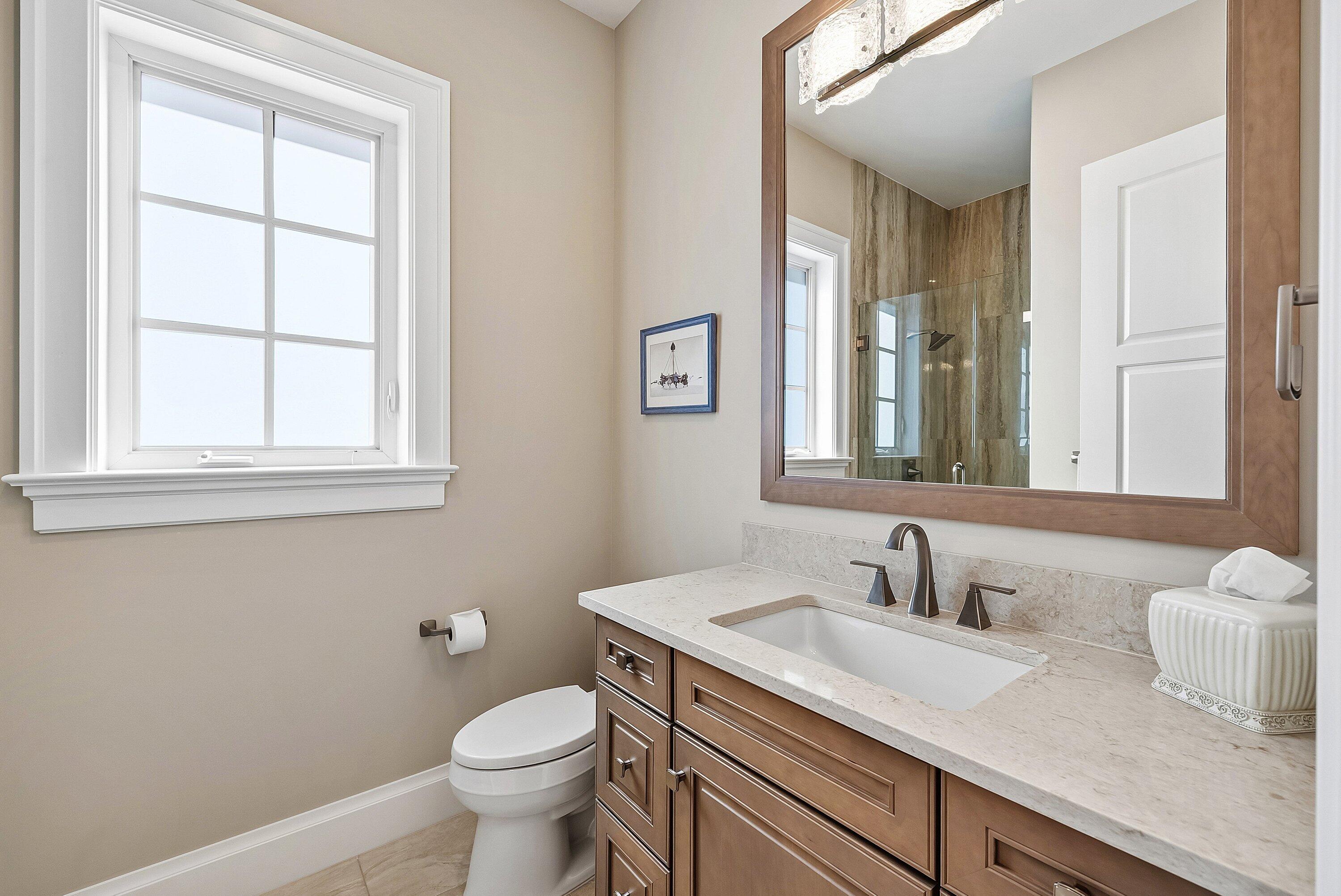 201 Northeast 3rd Court Boca Raton, FL 33432 - Photo 26 of 84 a bathroom with a granite countertop sink toilet and mirror
