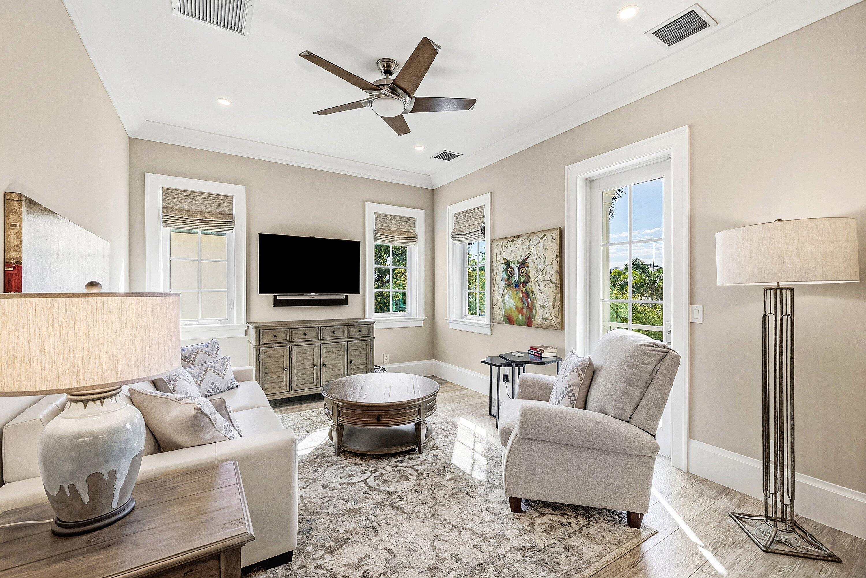 201 Northeast 3rd Court Boca Raton, FL 33432 - Photo 38 of 84 a living room with furniture and a flat screen tv